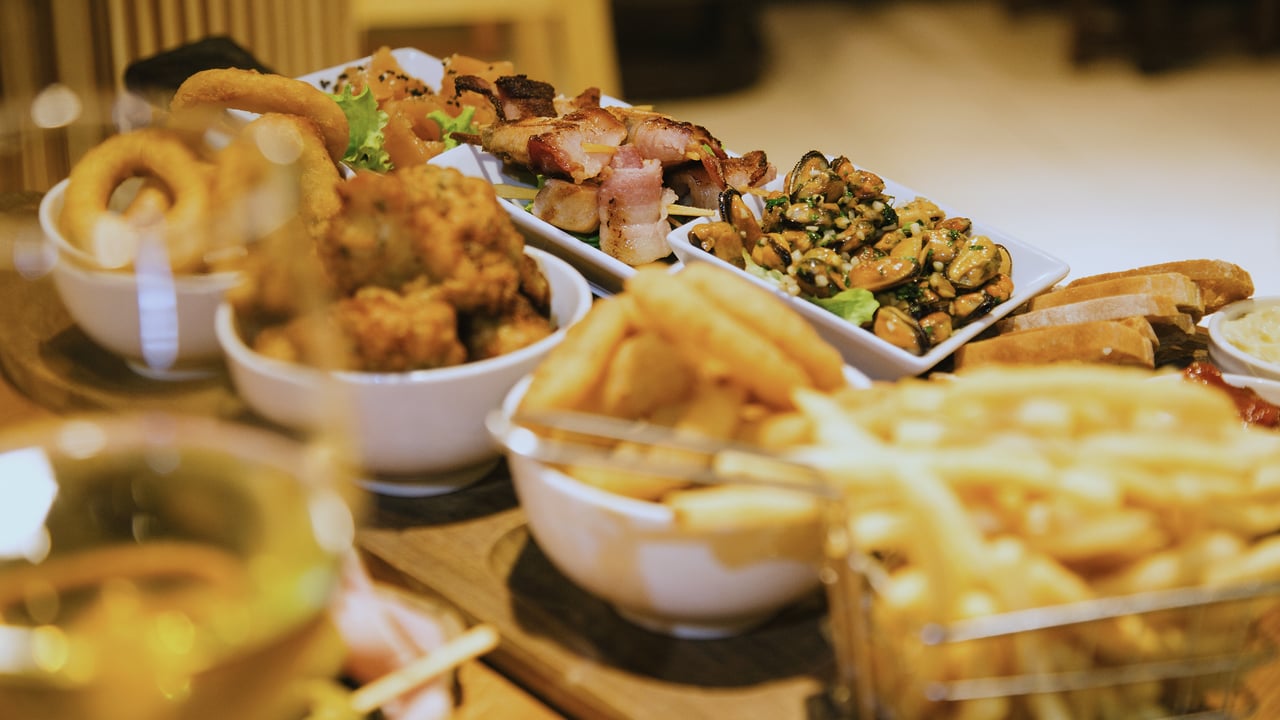 Picada de mar: aros de cebolla, rebozados, brochette de panceta, mejillones y una canasta de papas fritas